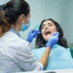 Woman at the dentist oral health assessment