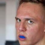 sweaty young boxer wearing mouthguard during