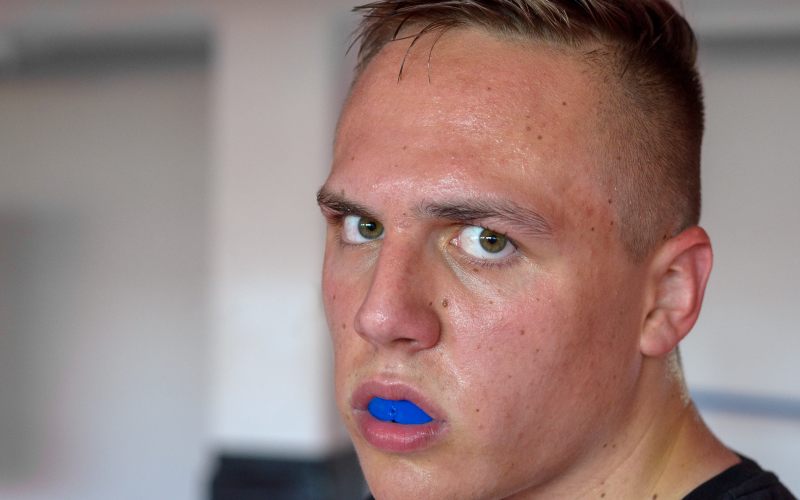 sweaty young boxer wearing mouthguard during
