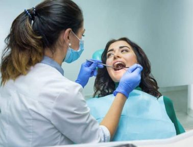 Woman at the dentist oral health assessment
